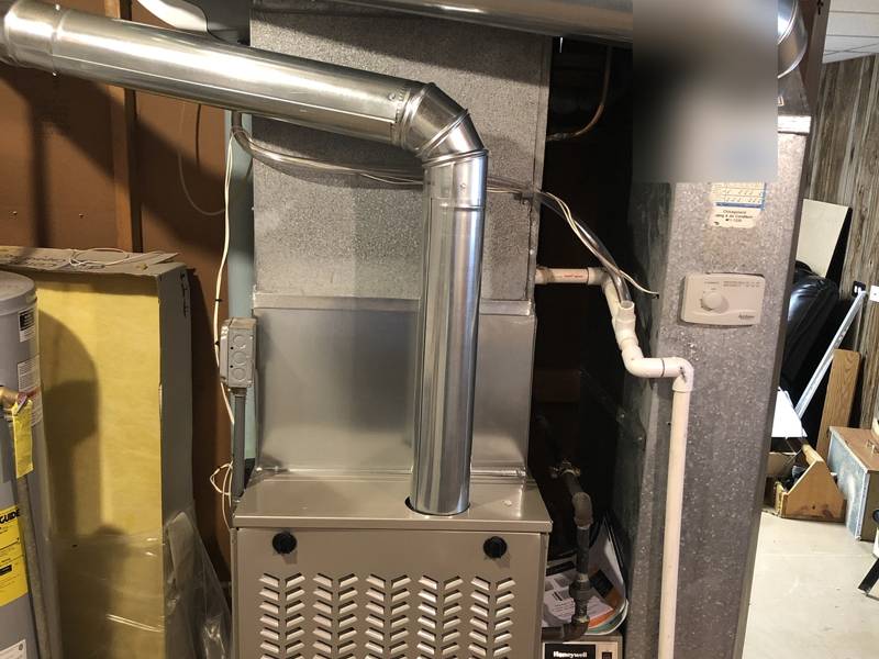 New high-efficiency furnace with new venting in a basement