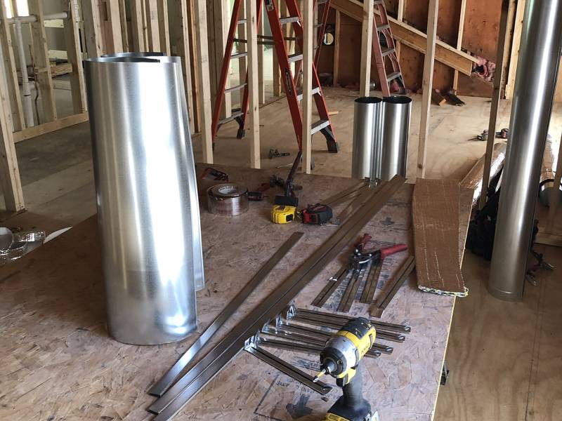 Duct pipe and hangers staged for the install