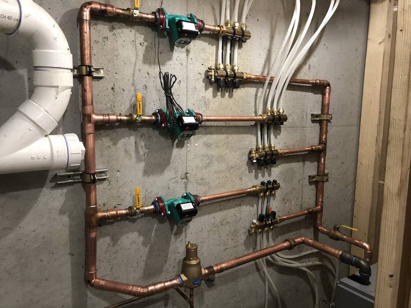 Boiler room with three zone pumps and radiant manifolds