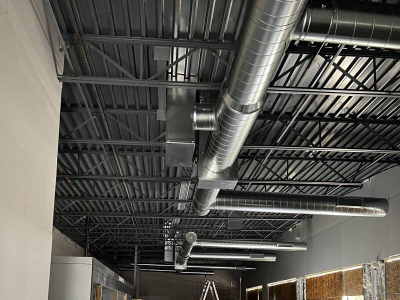 Spiral duct mains in a new retail buildout