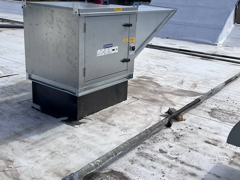 Exhaust fan on a roof curb