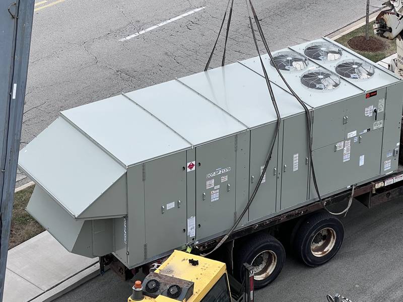 Packaged rooftop unit lifted into place