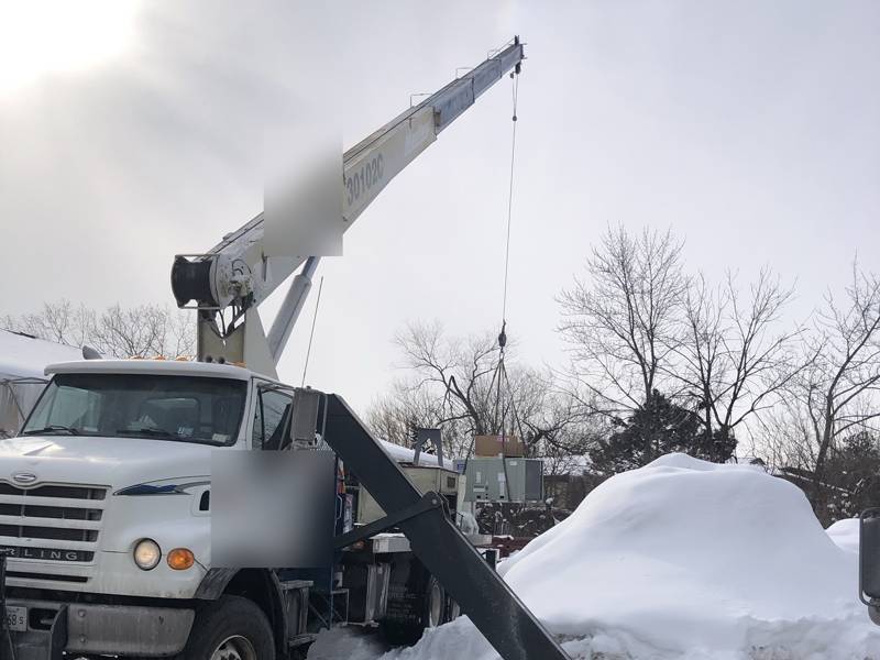 Crane set up for a winter rooftop lift