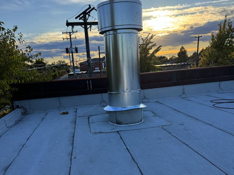 Exhaust stack with roof flashing